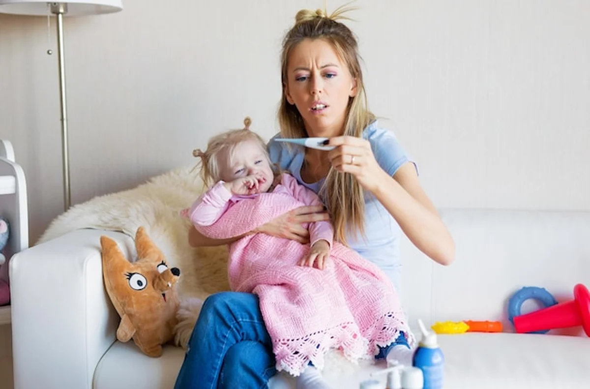 Matka mierzy temperaturę płaczącego dziecka